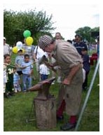 Bill demonstrating colonial blacksmithing.